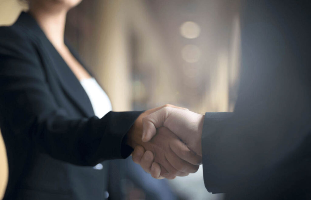 Female executive handshake in a boardroom