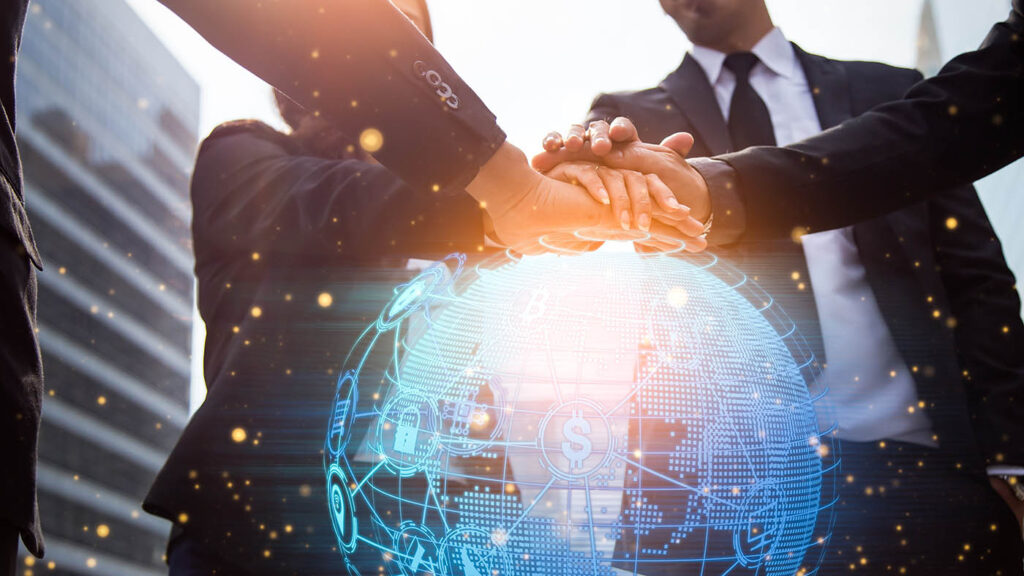Close up of businessmen shaking hands with global network